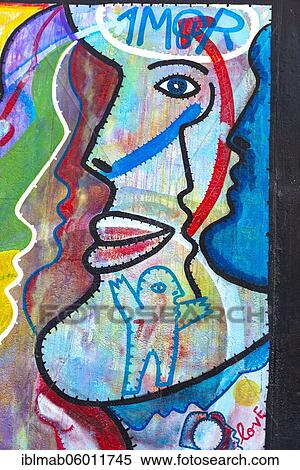Graffiti O Povo Unido Nunca Mais Sera Veicido with colorful face, artist Joaquim A. Goncalves Borregana, mural, East Side Gallery, Mauergalerie, Berlin, Germany, Europe View Large Photo Image Stock Photography - Graffiti O Povo Unido Nunca Mais Sera Veicido with colorful face, artist Joaquim A. Goncalves Borregana, mural, East Side Gallery, Mauergalerie, Berlin, Germany, Europe. Fotosearch
