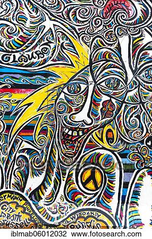 Graffiti We are one people, mural with colorful laughing face and peace symbol, artist Shamil Gimayev, East Side Gallery, Friedrichshain, Berlin, Germany, Europe View Large Photo Image Stock Image - Graffiti We are one people, mural with colorful laughing face and peace symbol, artist Shamil Gimayev, East Side Gallery, Friedrichshain, Berlin, Germany, Europe. Fotosearch