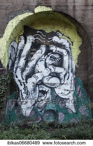 Stock Photo - Graffito, desperate man holds hands in front of face, screams, scared, dramatic, Düsseldorf, North Rhine-Westphalia, Germany, Europe. Fotosearch