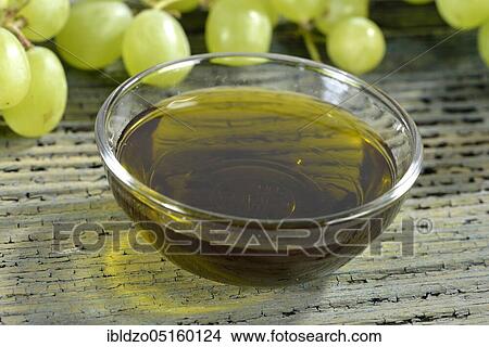 Picture - Grape seeds and grape seed oil (Vitis vinifera subsp. vinifera), grape seed oil. Fotosearch