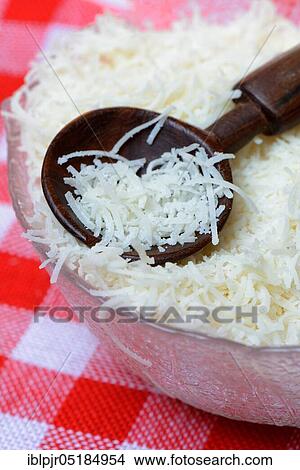 Grated Parmesan cheese in glass bowl with wooden spoon, Parmigiano Reggiano View Large Photo Image Picture - Grated Parmesan cheese in glass bowl with wooden spoon, Parmigiano Reggiano. Fotosearch