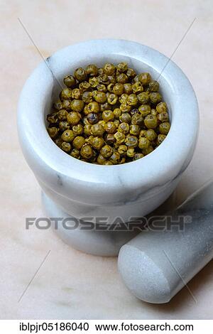 Stock Image - Green pepper in mortar, preserved with a little oil and then freeze-dried, plantation Ambolikapiky, Madagascar, Africa. Fotosearch