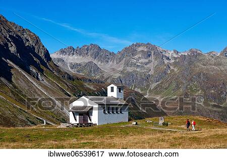 Stock Photo - Hiker at the Barbarakapelle, Bielerhöhe, Silvretta High Alpine Road, Vorarlberg, Austria, Europe. Fotosearch