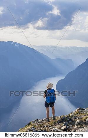 Hiker, evening mood at the top of the mountain Prest, fjord Aurlandsfjord, Aurland, Norway, Europe View Large Photo Image Stock Photography - Hiker, evening mood at the top of the mountain Prest, fjord Aurlandsfjord, Aurland, Norway, Europe. Fotosearch