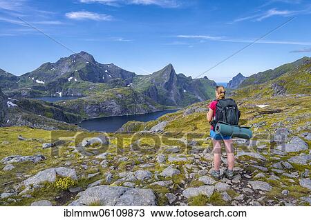 Hiker looks out over the lake Tennesvatnet, hike to Munkebu cabin, mountains, near Sørvågen, Lofoten, Nordland View Large Photo Image Stock Image - Hiker looks out over the lake Tennesvatnet, hike to Munkebu cabin, mountains, near Sørvågen, Lofoten, Nordland. Fotosearch