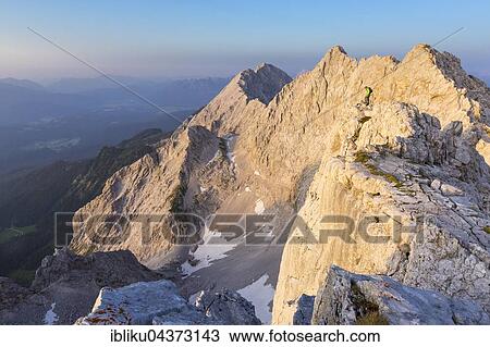 Hikers in the evening light on the Dreitörlspitzen, Hausberg the Meilerhütte, Wetterstein, Garmisch-Partenkirchen District, Bavaria, Germany, Europe View Large Photo Image Stock Image - Hikers in the evening light on the Dreitörlspitzen, Hausberg the Meilerhütte, Wetterstein, Garmisch-Partenkirchen District, Bavaria, Germany, Europe. Fotosearch