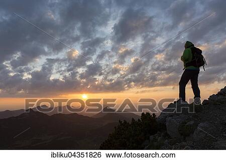 Hikers looking in the distance, sunrise at Krottenkopf, Ester Mountains, Garmisch-Partenkirchen District, Bavaria, Germany, Europe View Large Photo Image Stock Photograph - Hikers looking in the distance, sunrise at Krottenkopf, Ester Mountains, Garmisch-Partenkirchen District, Bavaria, Germany, Europe. Fotosearch