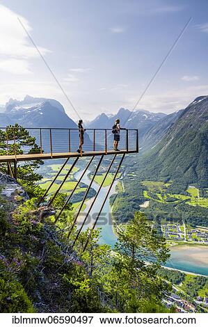 Hikers standing on viewing platform Rampestreken, hiking Romsdalseggen, river Rauma, Romsdalfjellene mountains, Andalsnes, Møre og Romsdal, Norway, Europe View Large Photo Image Stock Photo - Hikers standing on viewing platform Rampestreken, hiking Romsdalseggen, river Rauma, Romsdalfjellene mountains, Andalsnes, Møre og Romsdal, Norway, Europe. Fotosearch