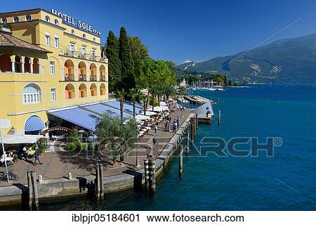 Stock Image - Hotel on the lake shore, promenade, Lake Garda, historical centre, Riva del Garda, Trentino, Province of Trento, Italy, Europe. Fotosearch