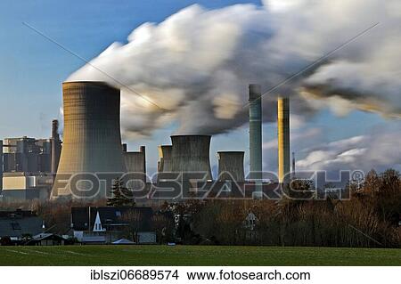 Houses of Rheidt in front of the lignite-fired power plant Niederaussem, Bergheim, Rhenish lignite mining area, North Rhine-Westphalia, Germany, Europe View Large Photo Image Picture - Houses of Rheidt in front of the lignite-fired power plant Niederaussem, Bergheim, Rhenish lignite mining area, North Rhine-Westphalia, Germany, Europe. Fotosearch