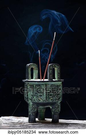 Picture - Incense burner with burning incense sticks. Fotosearch