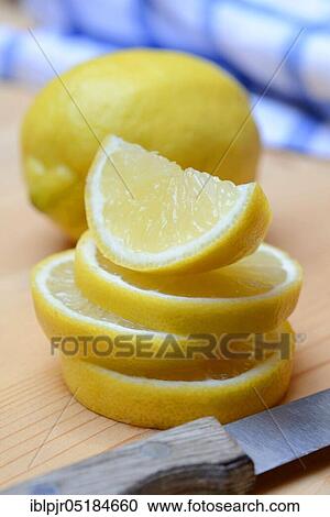 Stock Image - Lemon ( Citrus limon) slice, slices, quarters, quartered. Fotosearch