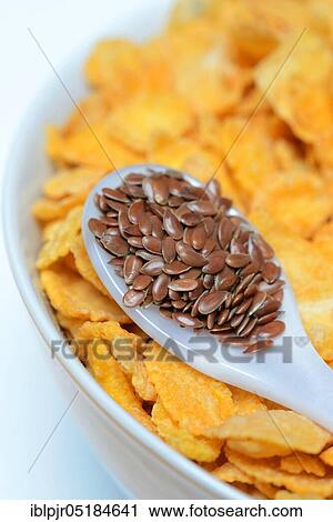Linseed ( Linum usitatissimum) in spoon and bowl with cornflakes View Large Photo Image Stock Image - Linseed ( Linum usitatissimum) in spoon and bowl with cornflakes. Fotosearch