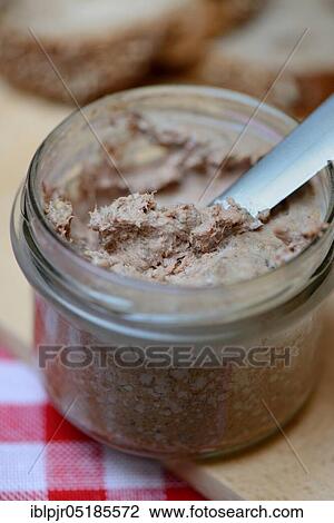Stock Image - Liver sausage in glass with knife, homemade liver sausage. Fotosearch
