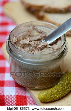 Stock Image - Liver sausage in glass with knife, homemade liver sausage. Fotosearch