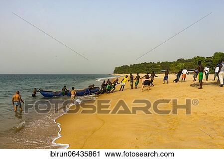 Local fishermen pulling their nets on a beach in Robertsport, Liberia, Africa View Large Photo Image Stock Image - Local fishermen pulling their nets on a beach in Robertsport, Liberia, Africa. Fotosearch