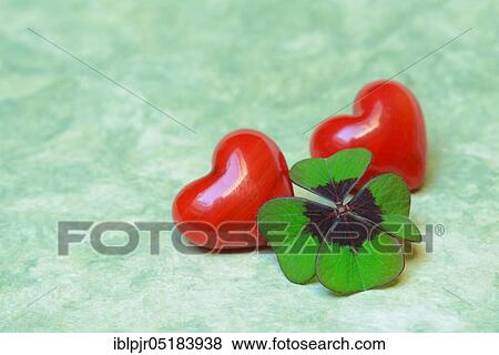 Stock Photo - Lucky Clover and red hearts, Clover, Lucky Clover, Four-leaf clover, Four-leaf clover. Fotosearch