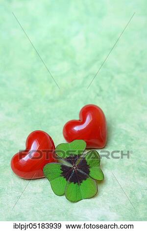 Stock Photo - Lucky Clover and red hearts, Clover, Lucky Clover, Four-leaf clover, Four-leaf clover. Fotosearch