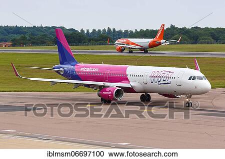 Stock Image - Luton (LTN), July 8, 2019: A Wizzair United Kingdom Airbus A321 with registration G-WUKJ at London Luton Airport in the United Kingdom, United Kingdom, Europe. Fotosearch