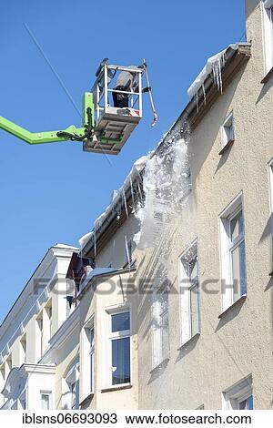 Man in lift knocks icicles off a gutter, Magdeburg, Saxony-Anhalt, Germany, Europe View Large Photo Image Stock Image - Man in lift knocks icicles off a gutter, Magdeburg, Saxony-Anhalt, Germany, Europe. Fotosearch