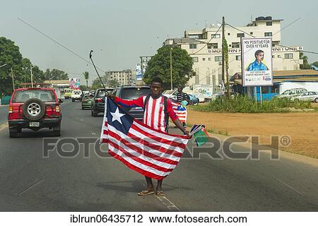 Man selling the flag of Liberia, Monrovia, Liberia, Africa View Large Photo Image Stock Image - Man selling the flag of Liberia, Monrovia, Liberia, Africa. Fotosearch