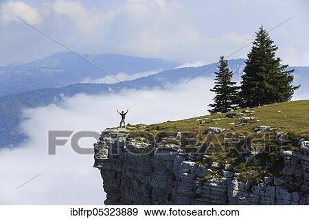 Stock Photo - Man standing edge of the Creux du Van, Neuchâtel, Neuchâtel Jura, Switzerland, Europe. Fotosearch