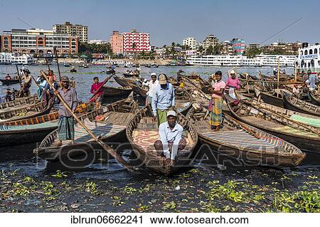 Stock Image - Men in their boats wiaitng for new clients, Port of Dhaka, Bangladesh, Asia. Fotosearch