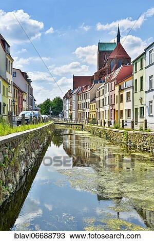 Stock Image - Millrace and St. Nikolai Church, Hanseatic City of Wismar, Mecklenburg-Western Pomerania, Germany, Europe. Fotosearch