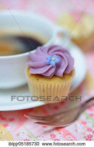 Mini cupcake and coffee cup View Large Photo Image Stock Image - Mini cupcake and coffee cup. Fotosearch