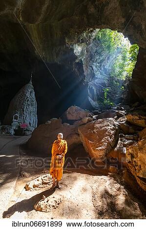 Stock Photo - Monk standing in Saddan cave, Hpa-An, Kayin state, Myanmar, Asia. Fotosearch