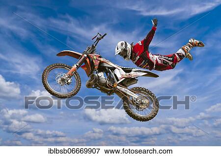 Motocross motorcycle and rider in the air, doing a stunt, Biberach, Baden-Württemberg, Germany, Europe View Large Photo Image Stock Photo - Motocross motorcycle and rider in the air, doing a stunt, Biberach, Baden-Württemberg, Germany, Europe. Fotosearch