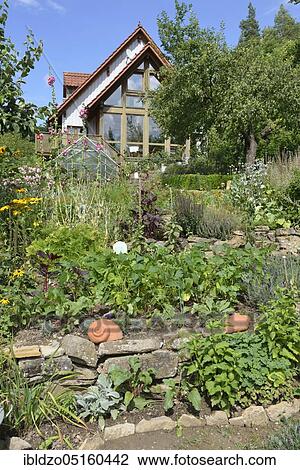 Natural garden with dry stone wall View Large Photo Image Stock Image - Natural garden with dry stone wall. Fotosearch