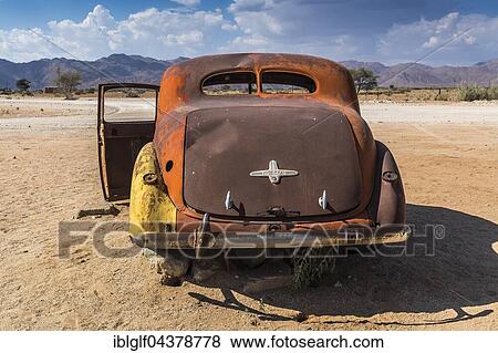Stock Photo - Old car wreck in sand, vintage car, Hudson, chassis, Solitaire, Namibia, Africa. Fotosearch