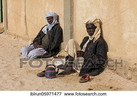 Stock Photo - Old man before a mosque in a village at Ounianga kebir part of the the Unesco sight Ounianga lakes, northern Chad, Africa. Fotosearch