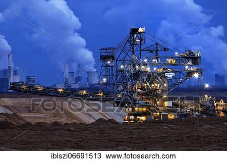 Opencast lignite mine with stacker and power plants in the evening, Garzweiler, Jüchen, Rhenish lignite mining area, North Rhine-Westphalia, Germany, Europe View Large Photo Image Stock Image - Opencast lignite mine with stacker and power plants in the evening, Garzweiler, Jüchen, Rhenish lignite mining area, North Rhine-Westphalia, Germany, Europe. Fotosearch