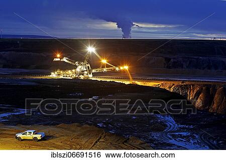 Opencast lignite mine with stacker in the evening, Garzweiler, Jüchen, Rhenish lignite mining area, North Rhine-Westphalia, Germany, Europe View Large Photo Image Stock Photograph - Opencast lignite mine with stacker in the evening, Garzweiler, Jüchen, Rhenish lignite mining area, North Rhine-Westphalia, Germany, Europe. Fotosearch
