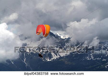 Paraglider in clouds over the Allgäu Alps, near Oberstdorf, Oberallgäu, Bavaria, Germany, Europe View Large Photo Image Stock Photo - Paraglider in clouds over the Allgäu Alps, near Oberstdorf, Oberallgäu, Bavaria, Germany, Europe. Fotosearch