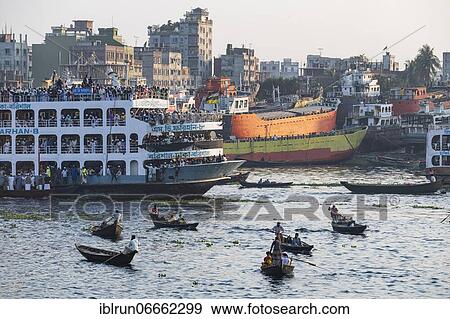 Passenger boats, port of Dhaka before a overloaded passenger ferry, Bangladesh, Asia View Large Photo Image Stock Photo - Passenger boats, port of Dhaka before a overloaded passenger ferry, Bangladesh, Asia. Fotosearch