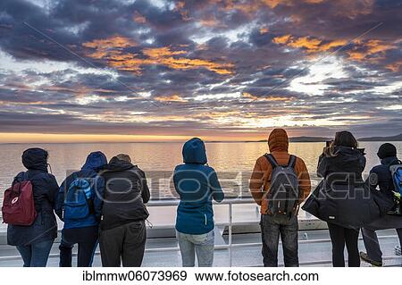 Passengers looking over the ocean, evening mood on the ferry in front of Lofoten, Lofoten, Nordland, Norway, Europe View Large Photo Image Stock Photo - Passengers looking over the ocean, evening mood on the ferry in front of Lofoten, Lofoten, Nordland, Norway, Europe. Fotosearch