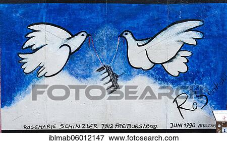 Peace doves carry the Brandenburg Gate, mural by artist Rosemarie Schinzler, East Side Gallery, Berlin, Germany, Europe View Large Photo Image Stock Photo - Peace doves carry the Brandenburg Gate, mural by artist Rosemarie Schinzler, East Side Gallery, Berlin, Germany, Europe. Fotosearch