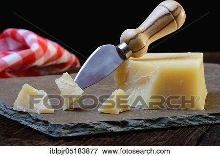 Stock Photo - Piece of Sbrinz cheese with cheese cutter, Swiss cheese, hard cheese, Switzerland, Europe. Fotosearch