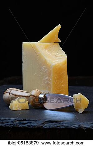 Stock Photo - Piece of Sbrinz cheese with cheese cutter, Swiss cheese, hard cheese, Switzerland, Europe. Fotosearch