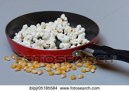 Popcorn in pan and corn kernels View Large Photo Image Picture - Popcorn in pan and corn kernels. Fotosearch