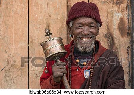 Picture - Portrait, Buddhist monk with prayer wheel, Shey Gompa, Dolpo, Nepal, Asia. Fotosearch