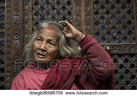 Portrait, elderly woman in front of carved wooden door, Patan, Kathmandu Valley, Nepal, Asia View Large Photo Image Stock Photo - Portrait, elderly woman in front of carved wooden door, Patan, Kathmandu Valley, Nepal, Asia. Fotosearch