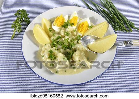 Stock Image - Potatoes and cauliflower in herb sauce. Fotosearch