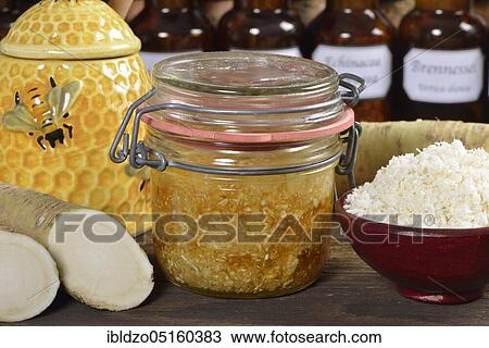 Stock Image - Production horseradish syrup (Cochlearia armoracia) with honey, horseradish. Fotosearch