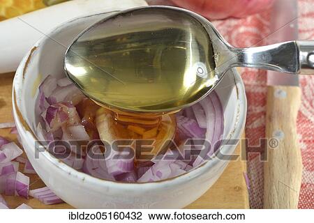 Stock Image - Production of onion syrup with brown sugar. Fotosearch