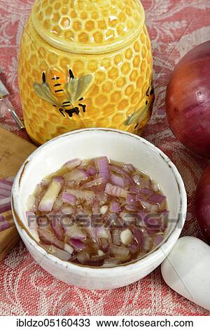 Stock Image - Production of onion syrup with brown sugar. Fotosearch