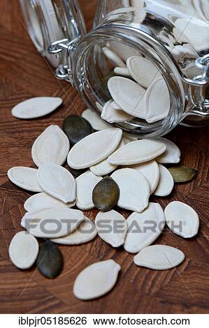 Stock Photograph - Pumpkincores ( Cucurbita) in storage glass. Fotosearch